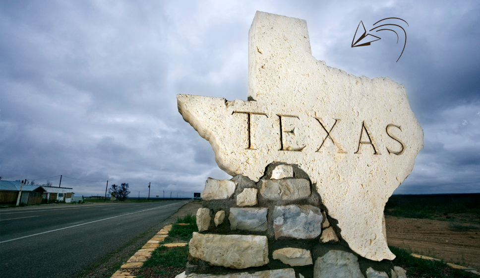 Texas state sign made of stone along a roadside." Caption: "Texas welcomes healthcare professionals to explore payroll loan options tailored to their needs." Description: "A stone sign in the shape of Texas by the roadside, representing the state’s welcoming approach to financial solutions for healthcare workers. This image reflects the stability and reliability of payroll loans designed specifically for Texas residents.