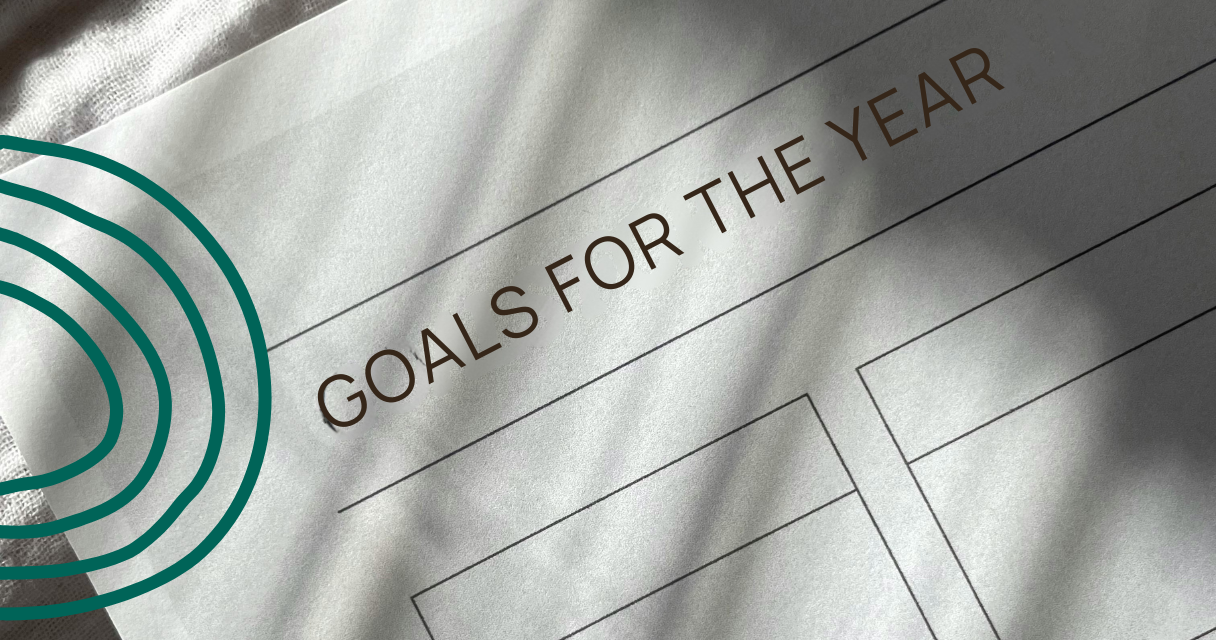 Close-up of a paper titled 'Goals for the Year,' featuring blank sections for planning and goal setting, emphasizing how to stick to resolutions in 2025