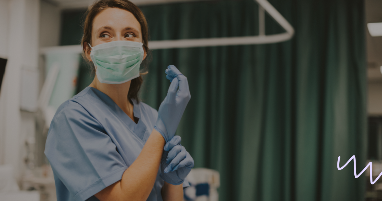 Nurse holding glove in a nurse certification course
